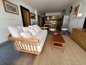 a living room with a couch and a table at Bastide le Petit Clos - les 2 Gîtes in Perpignan