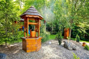 a wooden gazebo in the middle of a garden at Chata na Zbojskej - Zbojská in Pohronská Polhora