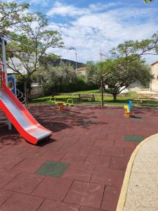 a playground with a slide in a park at Kuća za odmor Nada in Marina