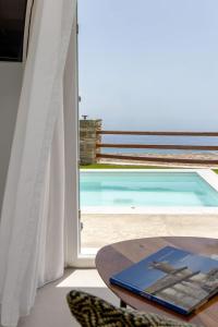 a room with a table and a view of a pool at Felicia Exclusive Villa - Private Pool in Arnados +22 photos