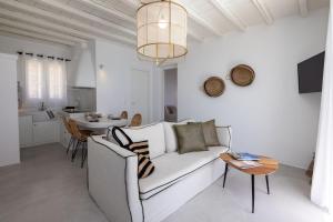 a white living room with a couch and a table at Felicia Exclusive Villa - Private Pool in Arnados