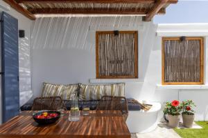a dining room with a table and a couch at Felicia Exclusive Villa - Private Pool in Arnados