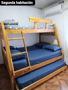 two bunk beds in a room with blue pillows at APARTAMENTOS LIZ MARIA in Coveñas