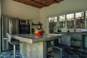 a person sitting at a kitchen island in a kitchen at Quinta Los Caballos in Ajijic