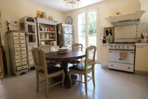 a kitchen with a table and chairs and a stove at LS7-468 - Eicela in Saint-Antonin-sur-Bayons