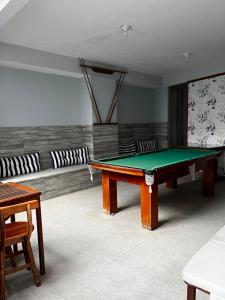 a room with a ping pong table and a couch at Pousada Caravela in Arraial do Cabo
