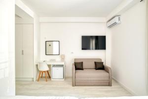 a living room with a chair and a desk at Hotel Opera Jaz in Budva