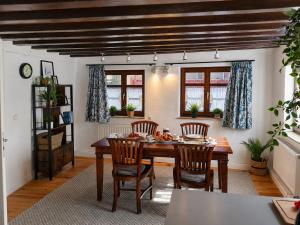 a dining room with a wooden table and chairs at Wohnung mit hist. Altstadt Charme in Nördlingen
