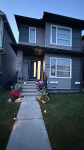 a house with a pathway leading to the front door at Entire 2BR Suite 12 min to Airport in Calgary