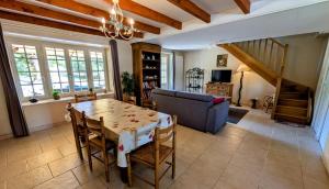 a living room with a table and a couch at La petite lisonne in Marval