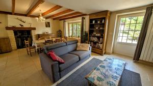 a living room with a couch and a dining room at La petite lisonne in Marval