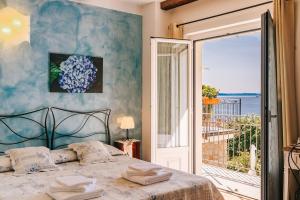 a bedroom with a bed with a view of the ocean at B&B Il Feriolo in Baveno