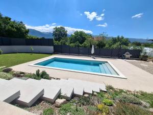 a swimming pool in the middle of a yard at Villa Velaris Mostar in Mostar