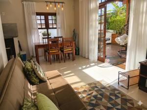 a living room with a couch and a table at Flat - SERRA E MAR - Paraty in Paraty