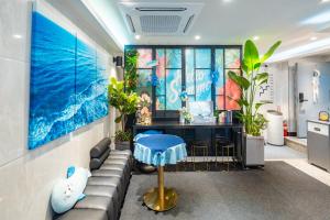 an office with a couch and a desk with plants at Stay JADE in Seoul