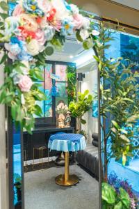 a mirror in a room with flowers and a stool at Stay JADE in Seoul
