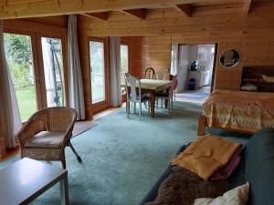 a living room with a bed and a table and chairs at Haus im Garten in Grebenau