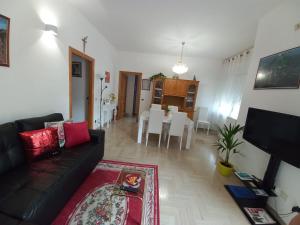 a living room with a couch and a dining room at Casa Stefy Gubbio in Gubbio