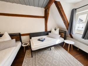a living room with a couch and a table at Wohnung mit hist. Altstadt Charme in Nördlingen