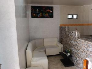 a living room with a couch and a chair at APARTAMENTOS LIZ MARIA in Coveñas +42 photos