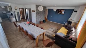 a living room with a table and a couch at Casa Loredana in Cârțișoara