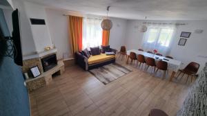 a living room with a couch and a table and chairs at Casa Loredana in Cârțișoara