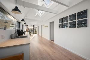 a hallway of a home with white walls and wood floors at Sortehus - 100 steps from the finest beach in Vallebo
