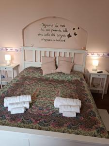 a bedroom with a large bed with towels on it at B&B TERRA DI COLLINA Relais-biker friendly-pool-sauna-jacuzzi in Montegrosso dʼAsti +93 photos