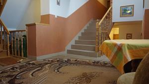 a room with a staircase with a bed and a rug at Wiktorowa Chata in Wierchomla Wielka +5 photos