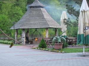 a gazebo with a person standing in it at Wiktorowa Chata in Wierchomla Wielka