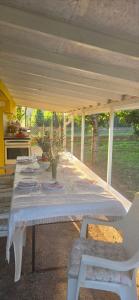 a table with a white tablecloth and two white chairs at Kod kapetana in Smederevo