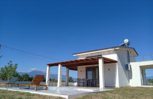 a house with a porch with a bench and a table at Nerina House in Paralia Katerinis +41 photos