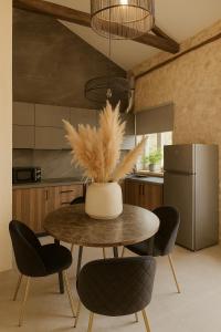 a kitchen with a table and chairs and a refrigerator at ArKa in Chania