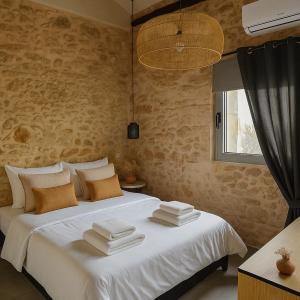 a bedroom with a large white bed with a window at ArKa in Chania
