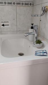 a bathroom sink with a faucet on top of it at Hostal Donde Rita in Vicuña