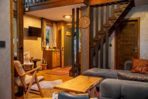 a living room with a couch and a staircase at Saffire Doğa Evleri in Güneyköy