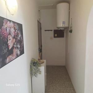 a hallway with a picture of a woman on the wall at Appartement PRIMAVERA in Armação de Pêra
