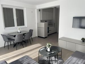 a living room with a table and a kitchen at BD Luxury Apartment in Bitola