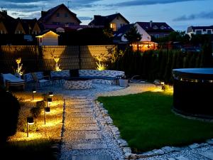 a backyard with a fire pit at night at Domki DOMINO w Darłówku nad morzem in Darłowo +22 photos