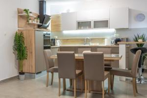 a kitchen with a wooden table and chairs at Holiday Home Gabriela in Sukošan
