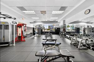a gym with a row of machines and weights at Luxury executive Studio in Brickell in Miami