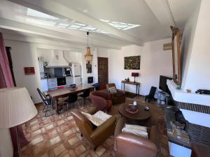 a living room with a couch and a table at Grande maison familiale proche mer in Elne