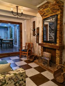 a living room with a checkered floor and a mirror at Hostal Posada Lupinos in Punta Arenas +33 photos