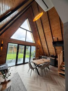 a dining room with a table and chairs at Cabana Mircea cel Bătrân in Arefu +23 photos