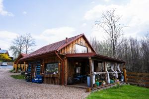 a log cabin with a store in the yard at Ranczo Lanckorona in Kalwaria Zebrzydowska