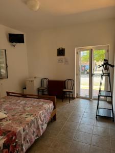 a bedroom with a bed and a room with a ladder at Agriturismo Bufaleria in Scanzano