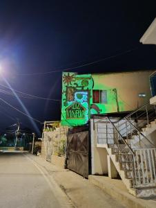 a sign on the side of a building at night at APARTAMENTOS LIZ MARIA in Coveñas