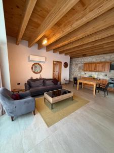 a living room with a couch and a table at Kaleli Deluxe Homes in Kaş
