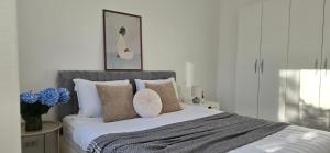 a bedroom with a large bed with pillows at Kamelija LUX in Đenovići