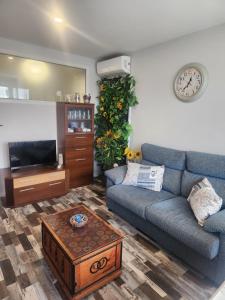 a living room with a couch and a table at Apartamento Sol in Suances